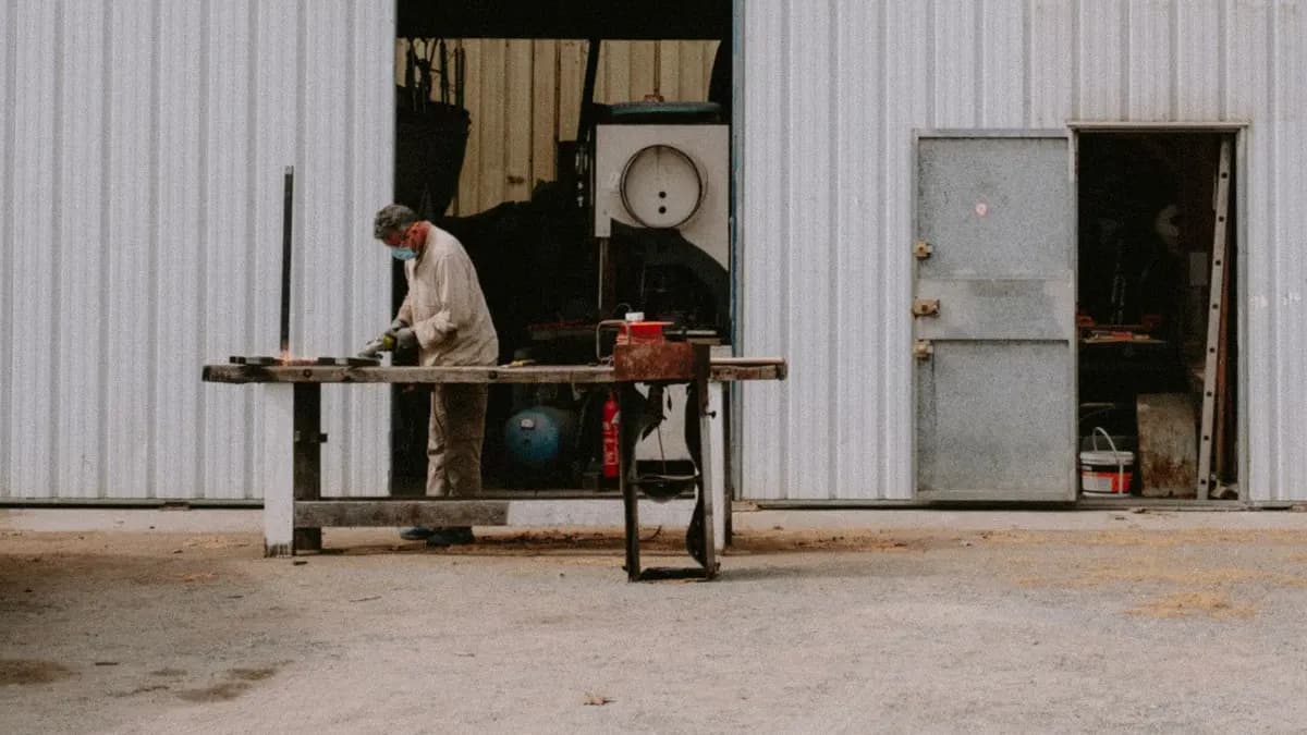 Worker wearing protective equipment during light metal fabrication