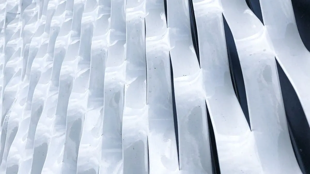 Modern architectural facade formed from reflective sheet metal panels