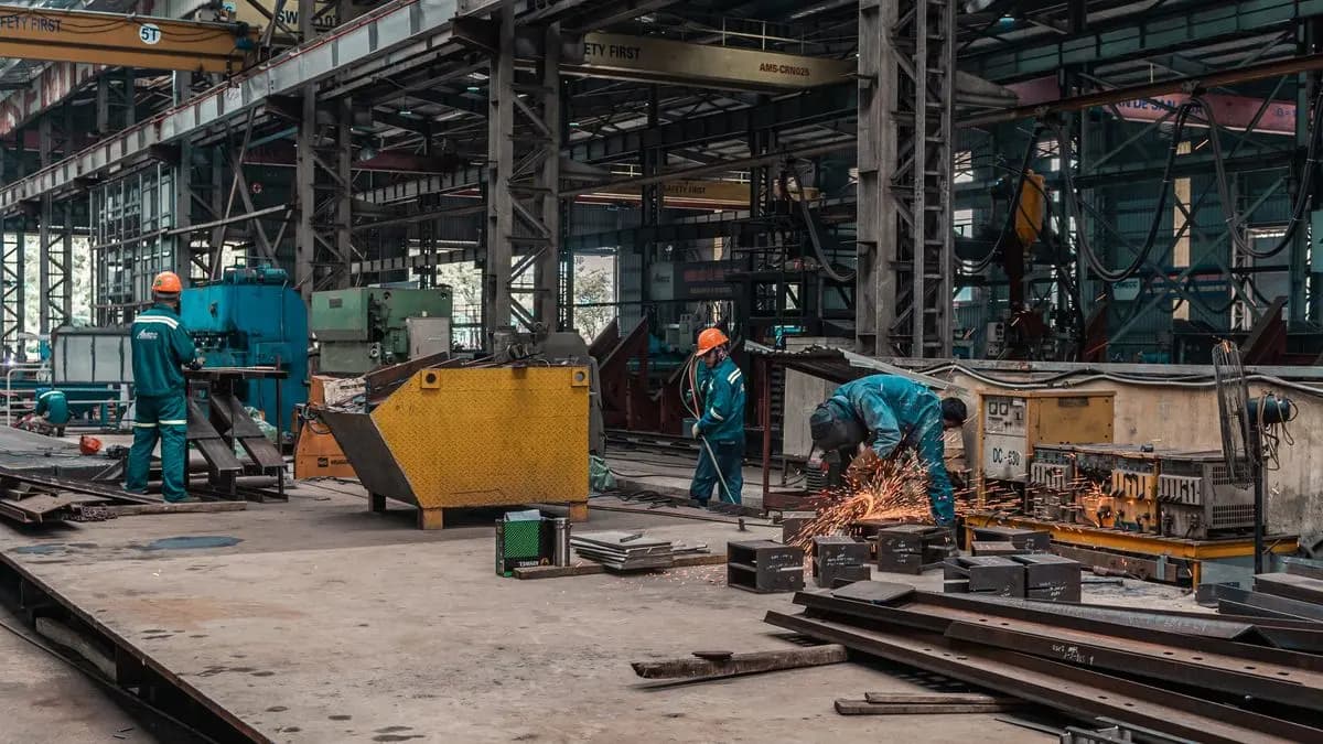 Metal fabrication team working across an industrial workshop floor