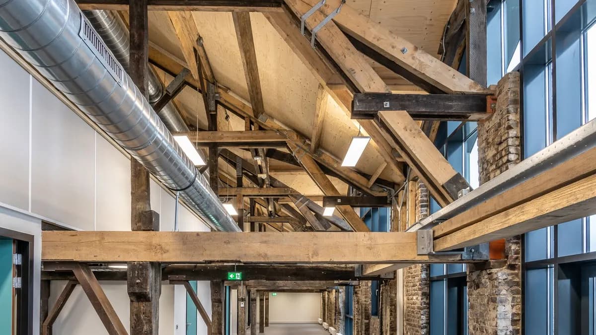 Large interior with exposed metal ventilation ducts and workshop-style services