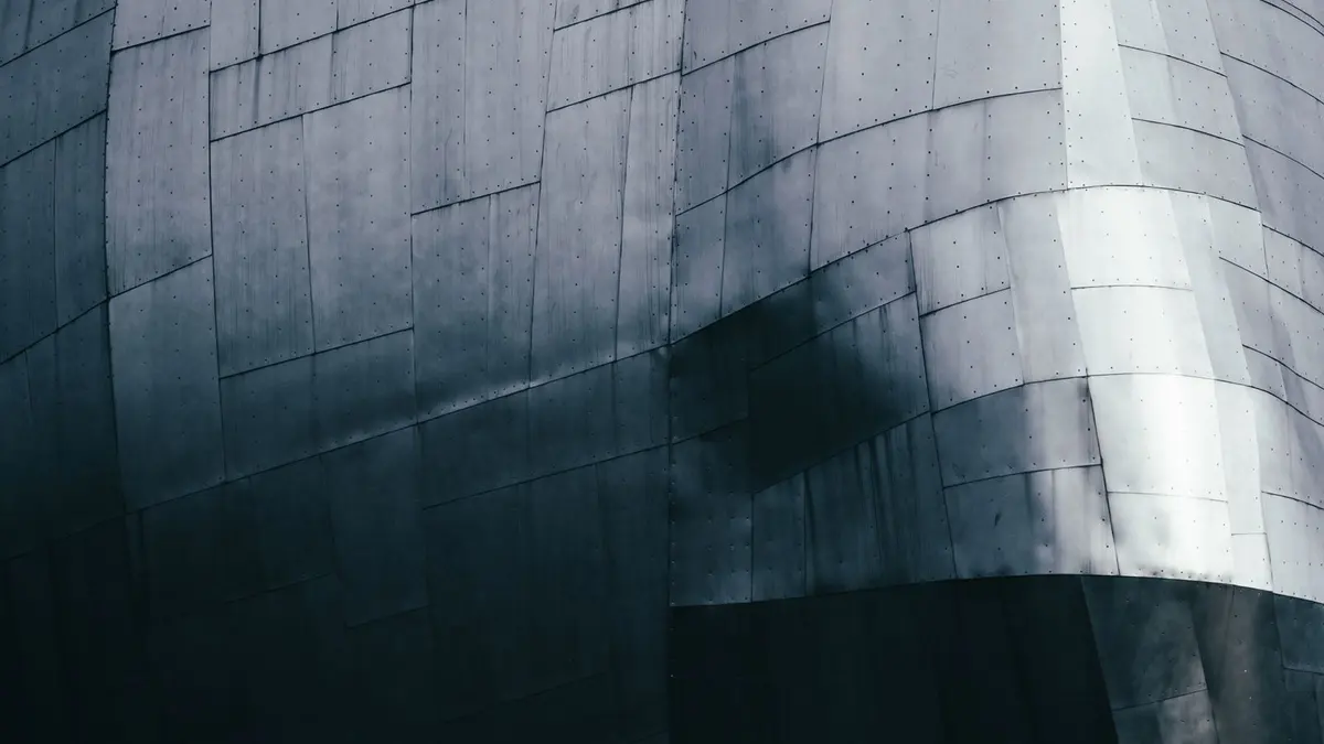 Modern building facade formed from reflective metal panels