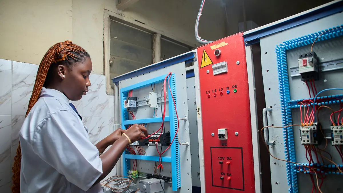 Technician working on an industrial electrical control enclosure