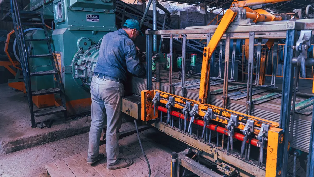 Machine operator working inside a general industrial workshop