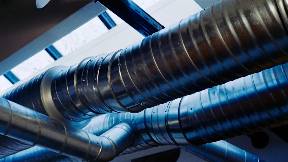 Modern industrial ventilation ductwork inside a large building
