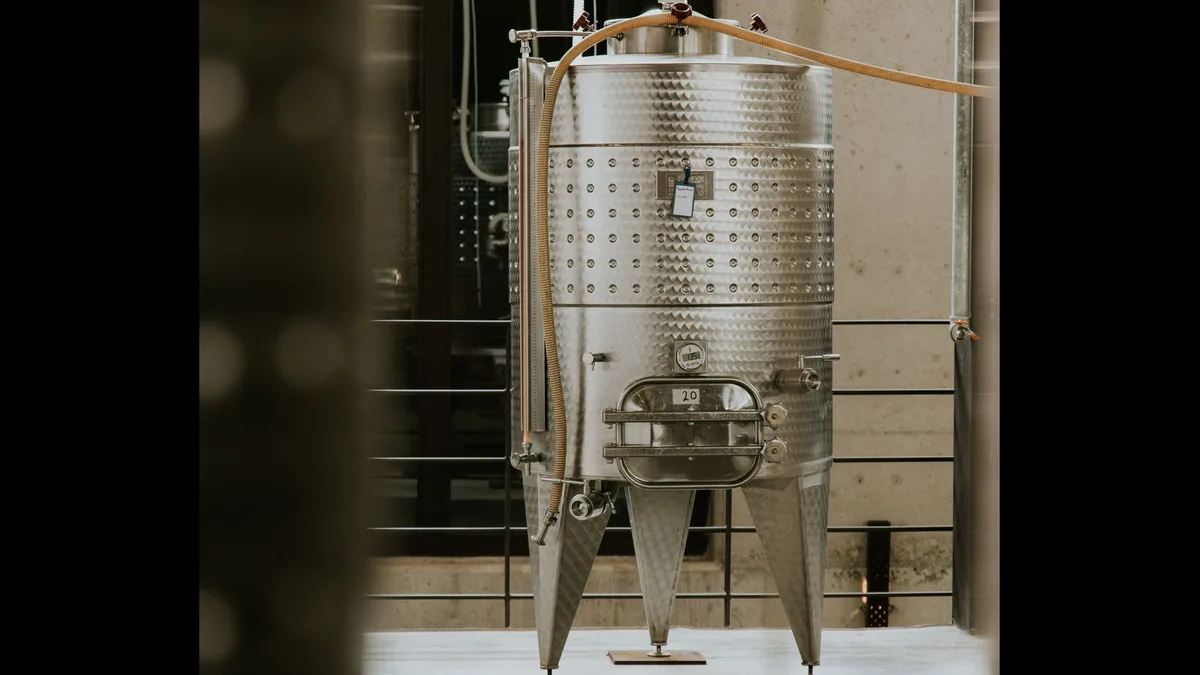 Real stainless steel cylindrical vessel in a processing facility